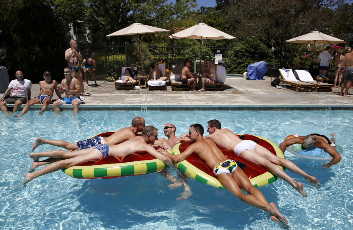 From left, Ryan Farley, Chris Wardell, Lance Retherford, Alan Le and Spence Harrell swim during pool party as part of Gay Wine Weekend at MacArthur Place on Sunday, June 21, 2015 in Sonoma, California. (Beth Schlanker / The Press Democrat)