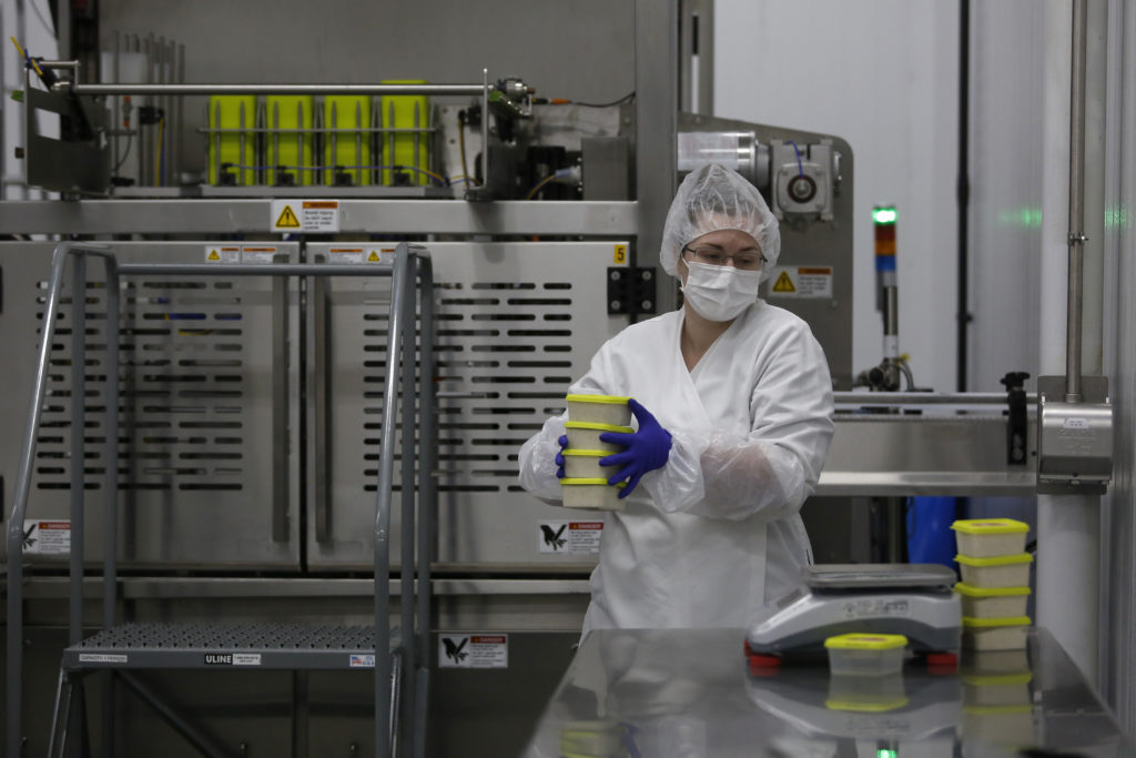 Quality assurance manager Olivia Slaugh prepares to weigh packages of a vegan French onion dip at Wild Brine Creamery in Santa Rosa, Calif., on Tuesday, August 17, 2021. (Beth Schlanker/The Press Democrat)