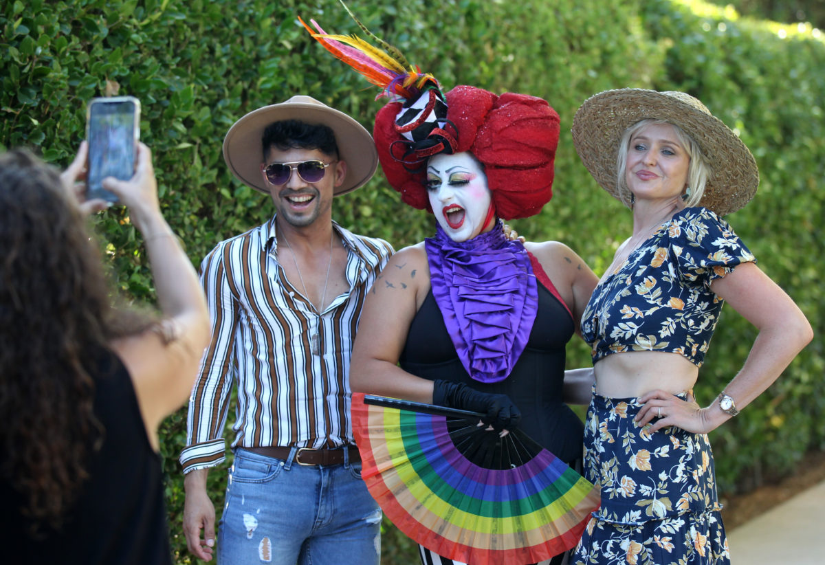 From left, Bogar Orea, of Suisun City, Calif., Maya Lane of Nevada City, Calif., and Hadley Larson of Sonoma, pose for a picture at Out In The Vineyard's "Twilight at Chateau St. Jean" benefit dance party, in Kenwood, Calif., on Saturday, July 17, 2021. (Photo by Darryl Bush / For The Press Democrat)