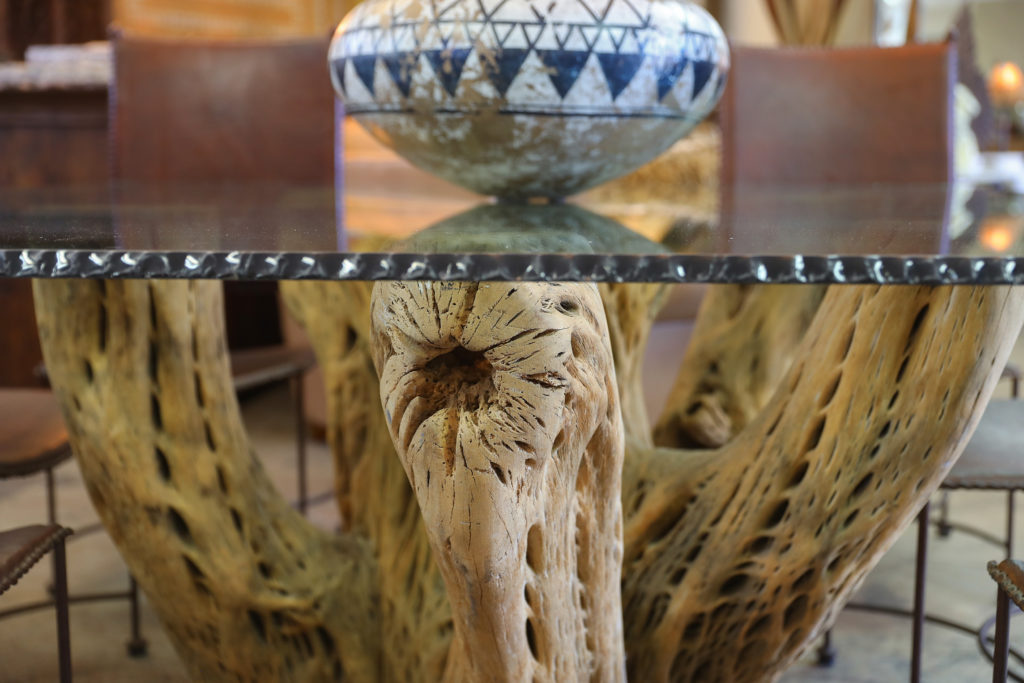 A table made from cactus root and glass imported from Mexico by furniture maker Jorge Martinez at his Wine Country Decor store in Santa Rosa. (Christopher Chung/The Press Democrat)