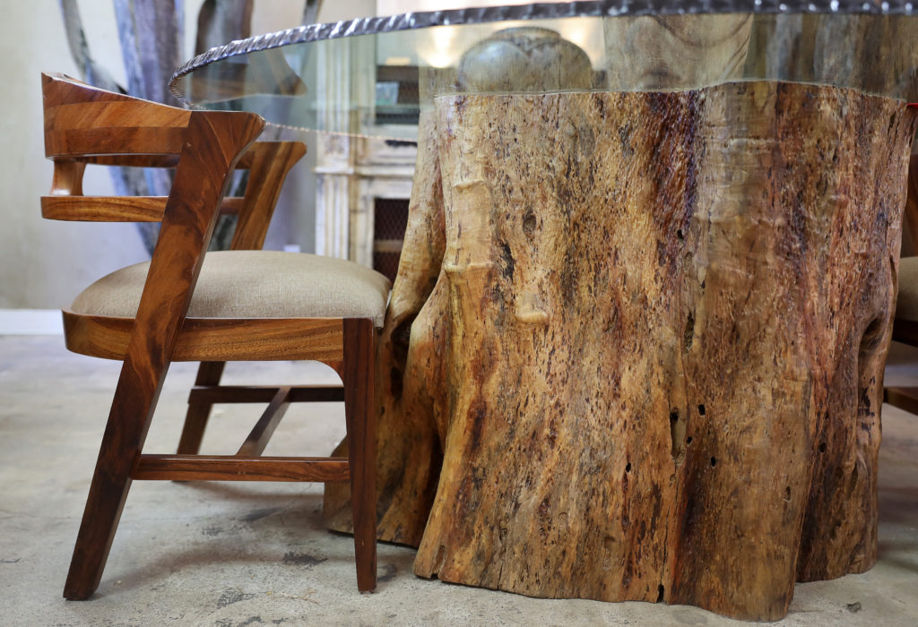 A table made from the trunk of a Guamuchil tree by Jorge Martinez at his Wine Country Decor store in Santa Rosa on Friday, May 7, 2021. The tree trunk and glass were both imported from Mexico. (Christopher Chung/The Press Democrat)
