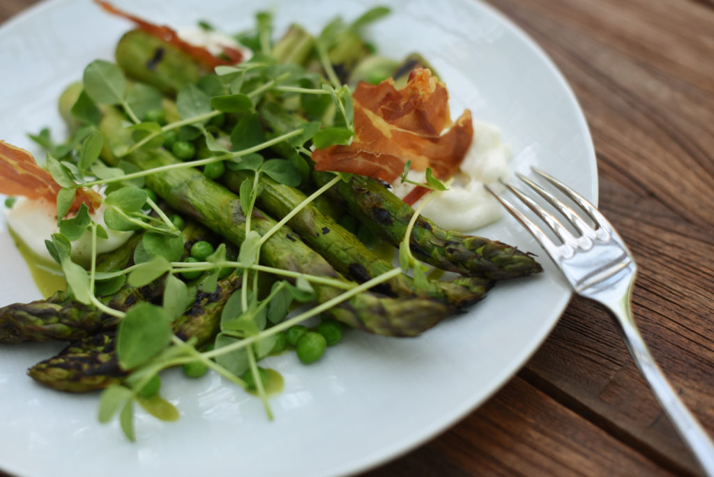 Burrata and grilled asparagus with crispy prosciutto, peas and black truffle vinaigrette at Layla restaurant at MacArthur Place Hotel and Spa in Sonoma, Calif. on Thursday, May 6, 2021. (Erik Castro/for The Press Democrat)