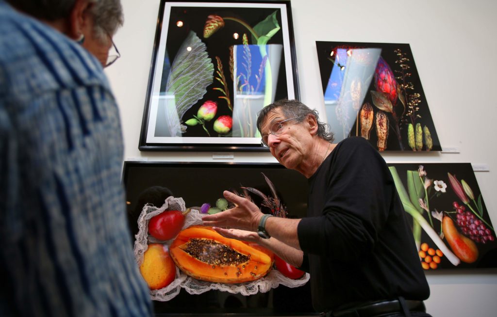 Artist Peter M. Krohn, right, talks with Judy Mathieson about his scanography of botanicals on aluminum in his studio, during the Sonoma County Art Trails Open Studio Tour, in Sebastopol on Sunday, October 12, 2014. (Christopher Chung/The Press Democrat)