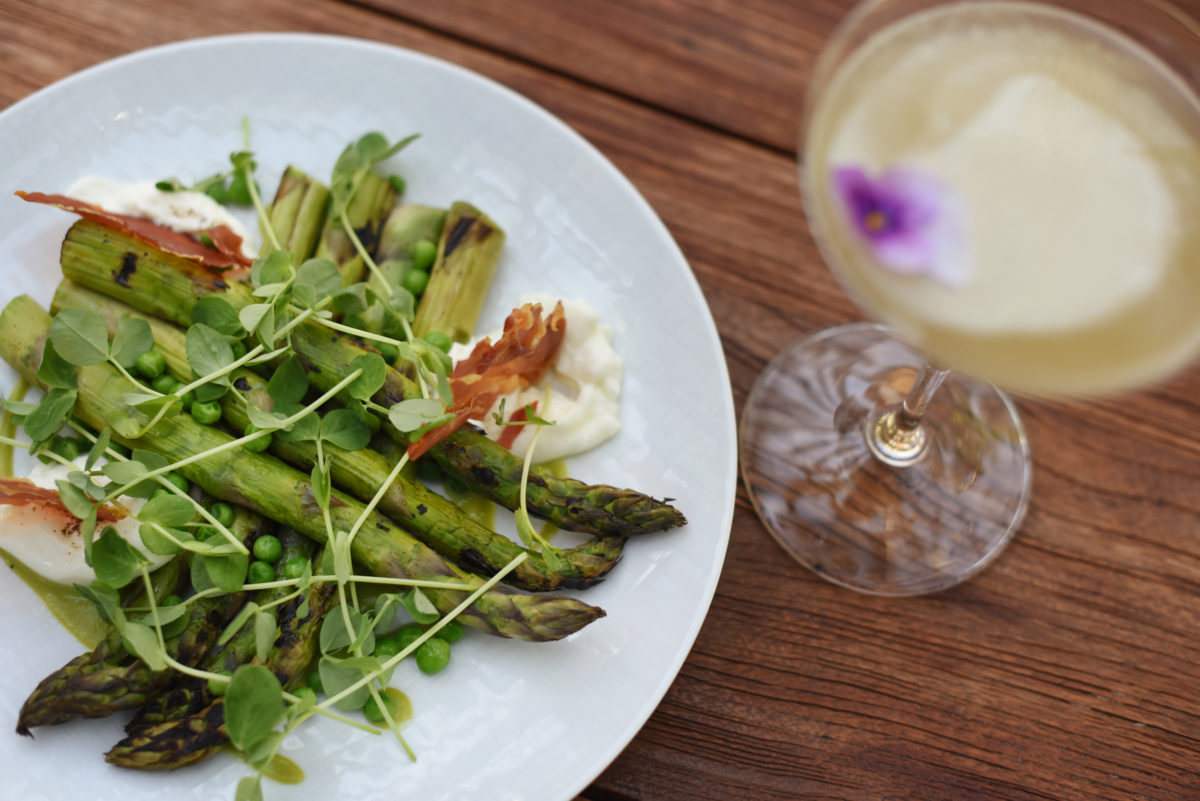 Burrata and grilled asparagus with crispy prosciutto, peas and black truffle vinaigrette, served with The Apiary cocktail made with gin, Yerba Mate tea, raw honey and lemon at Layla restaurant at MacArthur Place Hotel and Spa in Sonoma. (Erik Castro/for The Press Democrat)