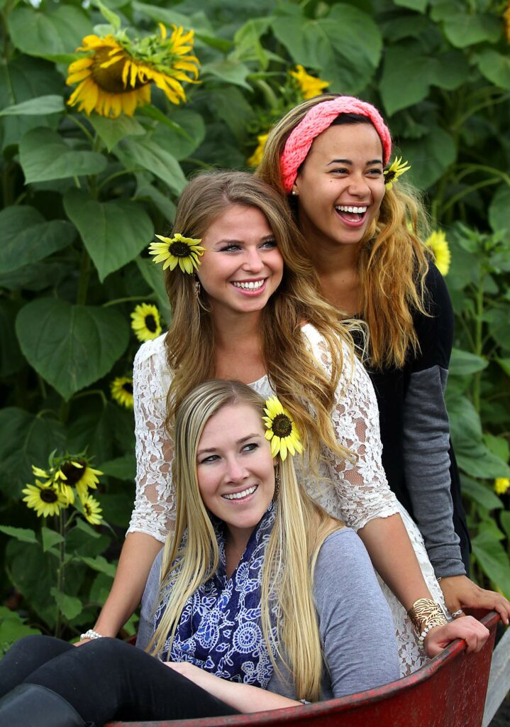 Alexis Lenahan, Desirae Braga and Aralyn Tucker pose for Facebook pictures in the Petaluma Pumpkin Patch and Amazing Corn Maze in Petaluma. (John Burgess/The Press Democrat)