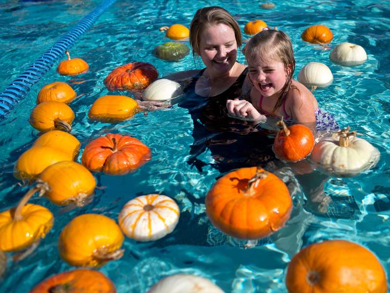 Donata Mikulik, left, and her daughter Viola, 4, swim among the floating pumpkins at Ridgeway Swim Center's annual floating pumpkin patch in Santa Rosa, Calif., on October 19, 2013. (Alvin Jornada / The Press Democrat)