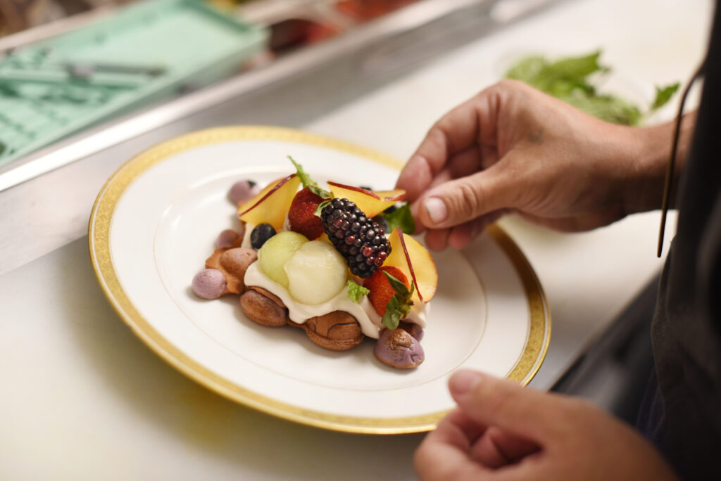 Chef/Co-Owner Jeremy Cabrera plating his Ube bubble waffle served with seasonal fruit, yogurt whipped cream, pure honeycomb and mint at 4th Street Social Club restaurant in downtown Santa Rosa, Calif., on Saturday, Sept. 18, 2021. (Erik Castro / For The Press Democrat)
