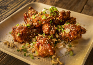Spicy Sweet Chile Chicken Wings with peanuts, scallions and sesame seeds from The Mill at Glen Ellen. (John Burgess/The Press Democrat)