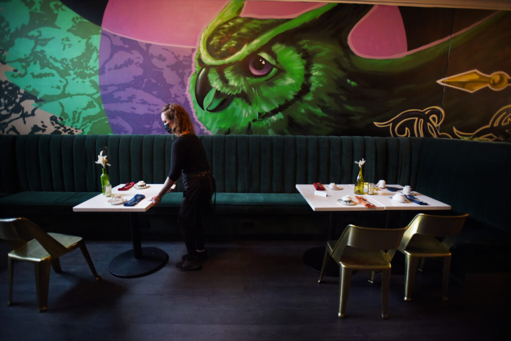 Owner Melissa Matteson making some final table adjustments before a brunch shift at 4th Street Social Club restaurant in downtown Santa Rosa, Calif., on Saturday, Sept. 18, 2021. Matteson runs the entire restaurant with only two others: Chef Jeremy Cabrera in the kitchen and her sole waiter Leonardo Santoni. (Erik Castro / For The Press Democrat)