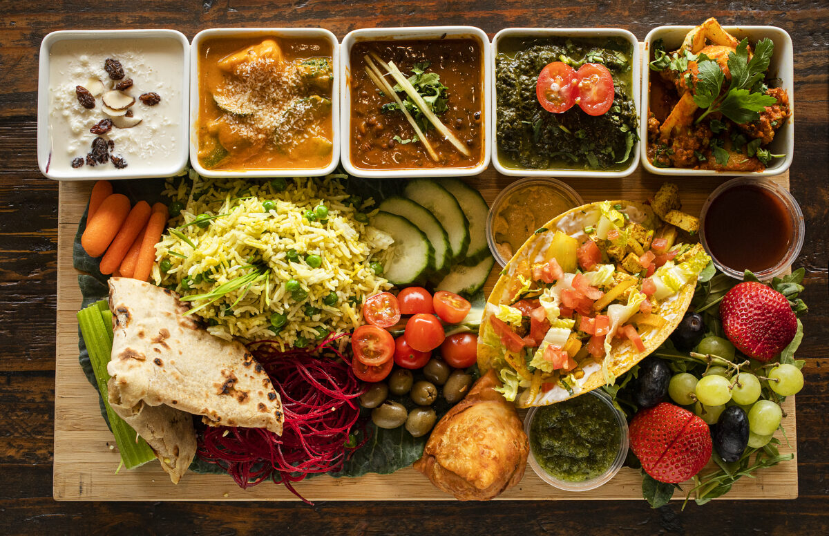 The Vegan platter includes (top, left to right) coconut kheer, vegetable coconut, Kali Dahl, Saag Aloo, Khile Phoolm with rice, chutneys, roti, fruit, olives, veggies and a tofu taco from Ambrosia in Petaluma. (John Burgess/The Press Democrat)