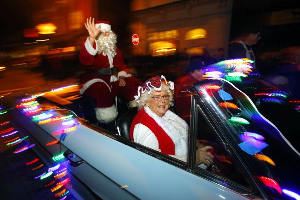 Mr. And Mrs. Clause make their way through in the Geyserville Tractor Parade along Geyserville Avenue on Saturday, November 29, 2014. (Conner Jay/Press Democrat)