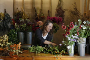 Tali Bouskila, owner of Flower Casita, builds a wreath at her shop in Petaluma. (Beth Schlanker/The Press Democrat)