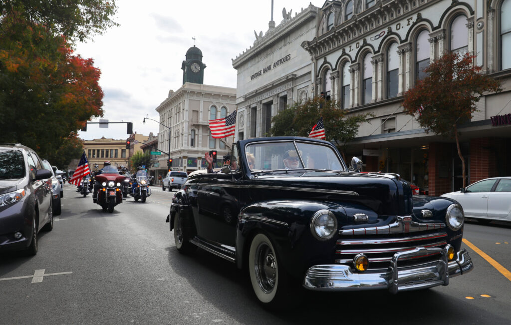 A Veterans Day vehicle procession makes its way along Petaluma Boulevard North in Petaluma on Wednesday, November 11, 2020. The traditional Veterans Day Parade had to be significantly scaled down due to the coronavirus pandemic. (Christopher Chung / The Press Democrat)