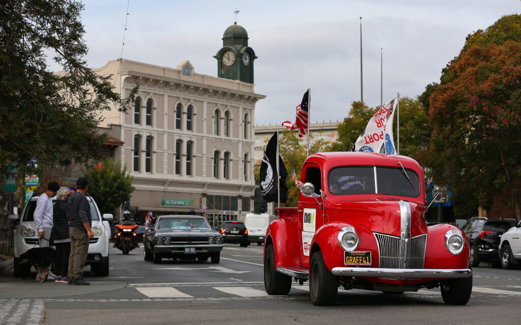 The Veterans Day vehicle procession drives along Petaluma Boulevard North in Petaluma on Wednesday, November 11, 2020. The traditional Veterans Day Parade had to be significantly scaled down due to the coronavirus pandemic. (Christopher Chung / The Press Democrat)