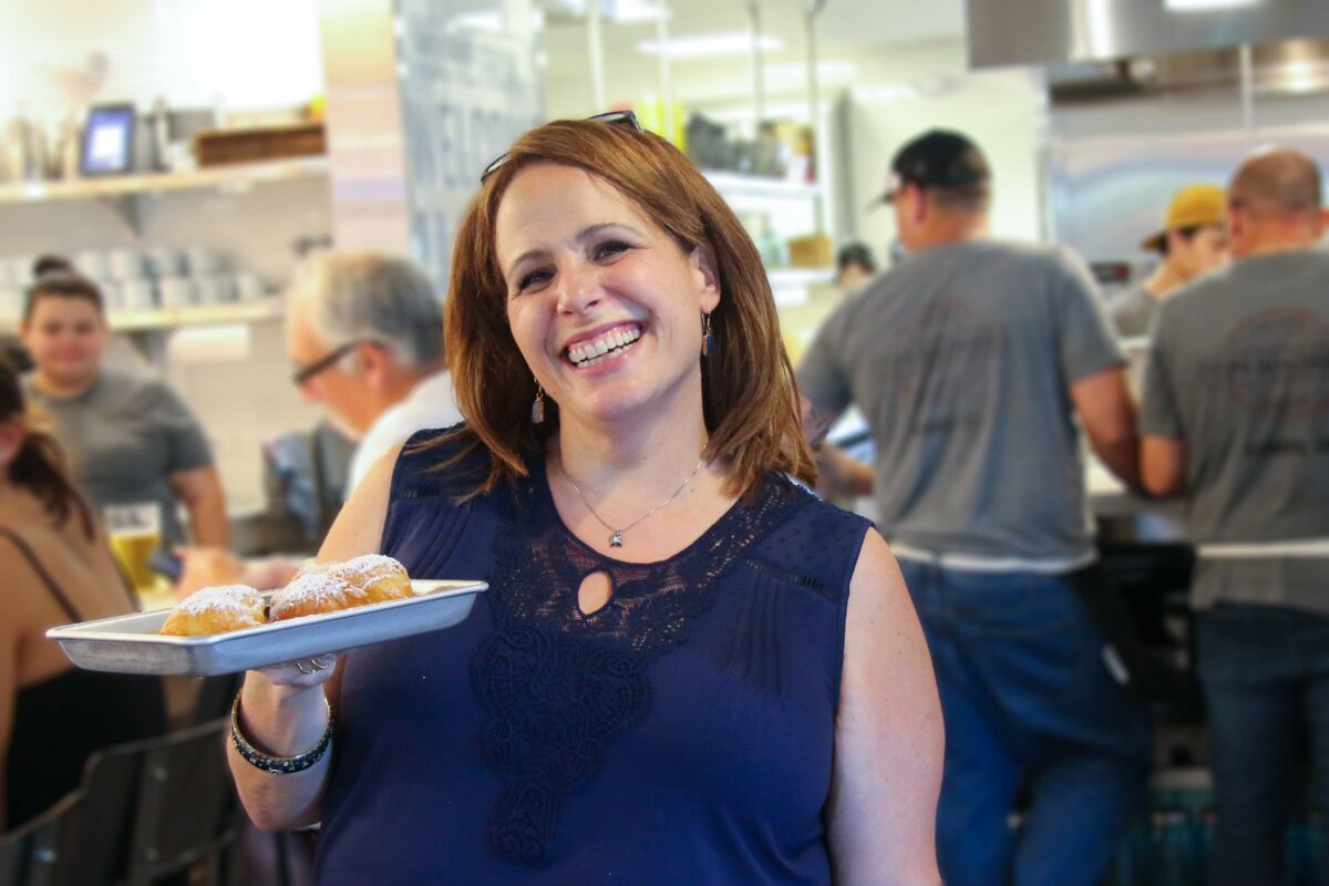 Owner Susie Pryfogle shows off beignets at Tips Roadside in Kenwood. (Heather Irwin/The Press Democrat)