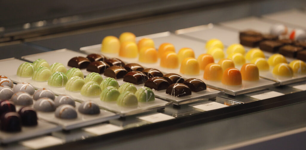 A variety of artisan chocolates sit in the case during the grand opening of Fleur Sauvage Chocolates in Windsor, Calif., on Wednesday, December 15, 2021. (Beth Schlanker/The Press Democrat)