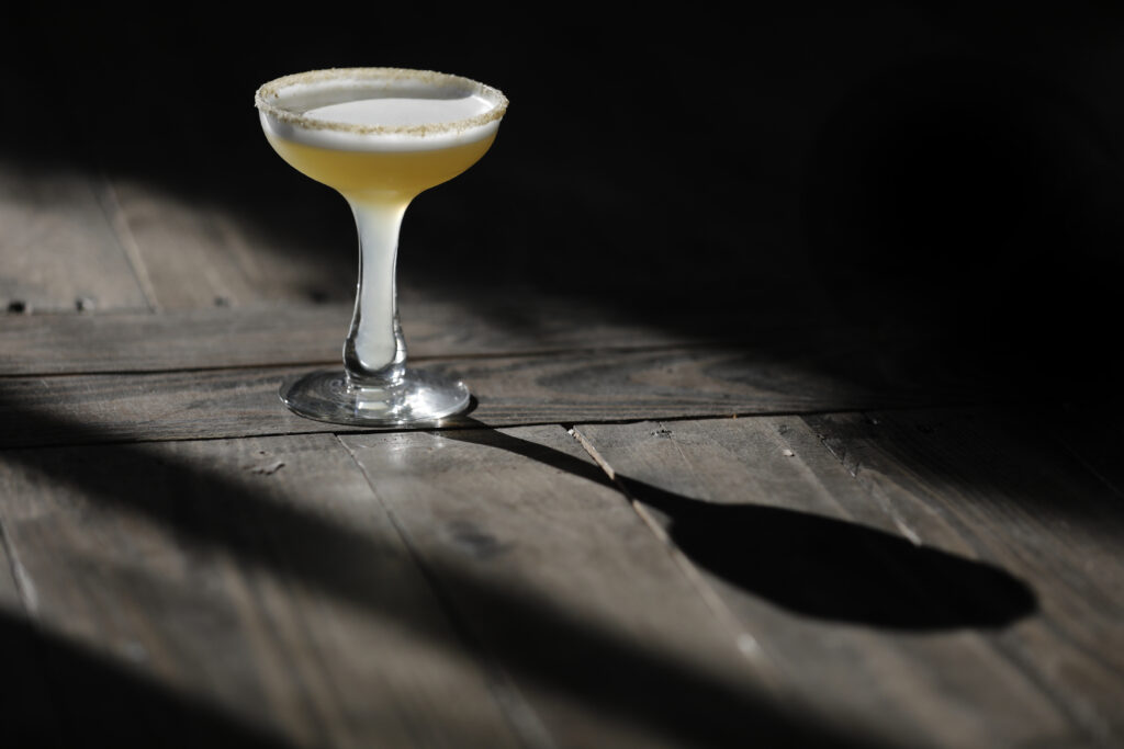 A Sicilian Sting, a mix of grappa, honey, lemon juice, egg white, with a chamomile sugar rim, at Barber Lee Spirits in Petaluma, on Thursday, Dec. 2, 2021. (Beth Schlanker/The Press Democrat)