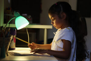 Hania Nazario, 5, a kindergartner at Cesar Chavez Language Academy, does her homework at home in Santa Rosa. (Christopher Chung/ The Press Democrat)