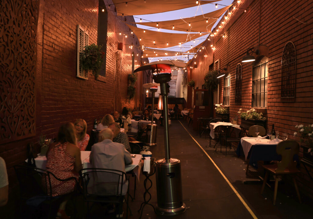 As restaurants thought of new ways to bring in customers during the pandemic, La Gare restaurant in Santa Rosa converted an alleyway to an outside dining area. (Kent Porter The Press Democrat) 