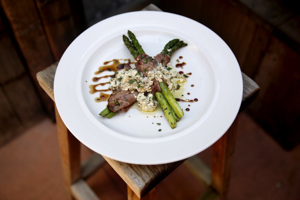 Grilled asparagus, ricotta cheese and coppa cotta at The Girl & The Fig in Sonoma, on Wednesday, May 27, 2015. (Beth Schlanker/The Press Democrat)