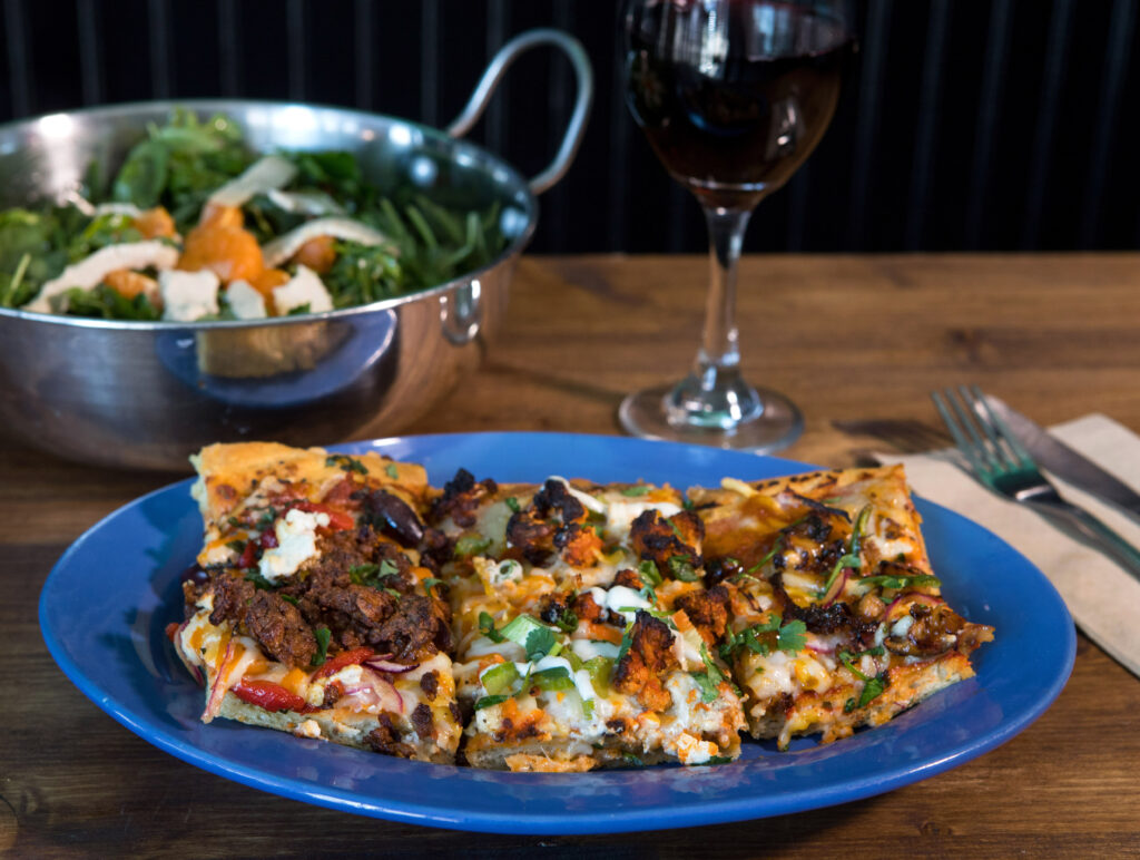 Vegan pizza and a signature salad at Magdelena's Savories & Sweets in Petaluma. (Darryl Bush/For The Press Democrat)