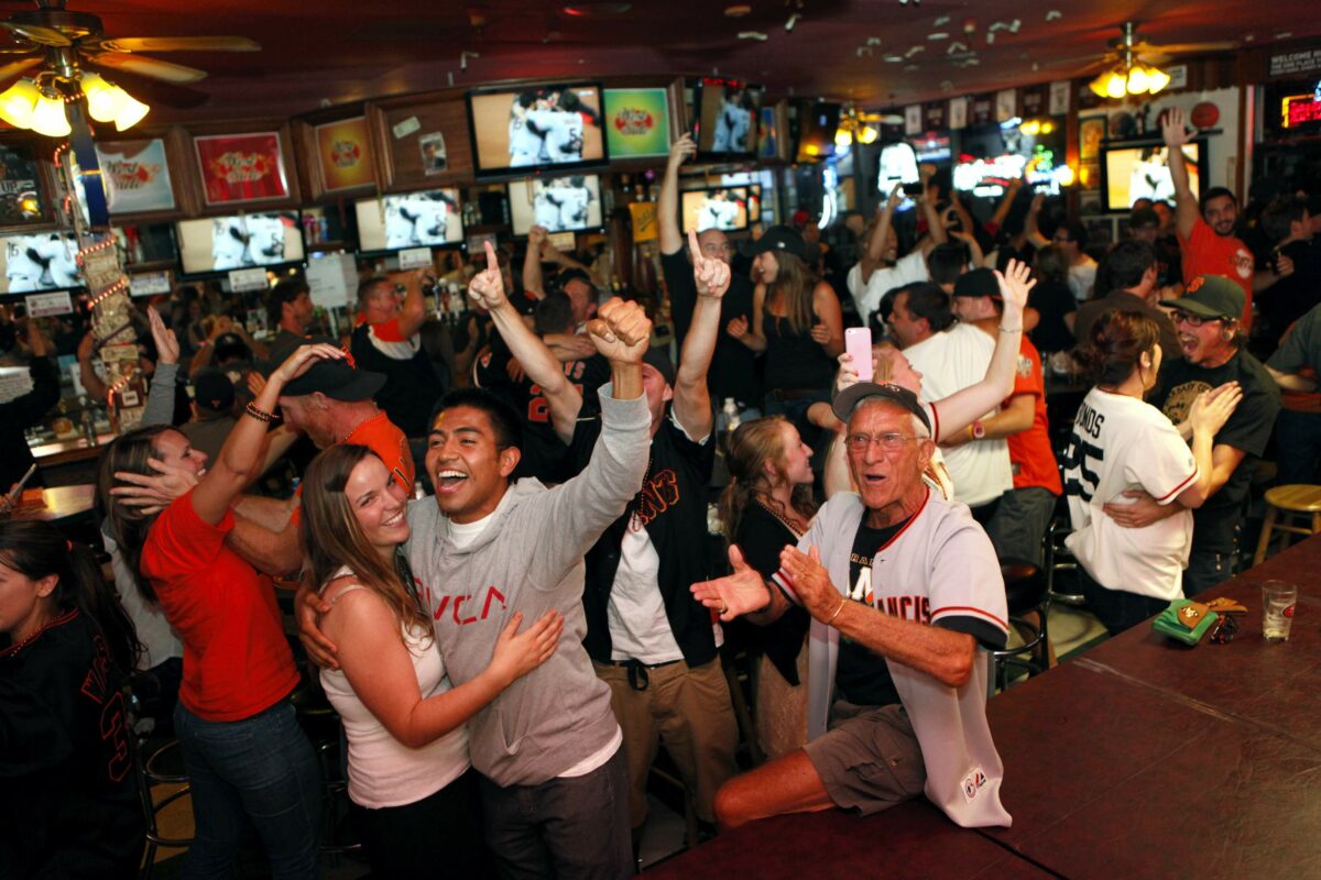 (Front row from left) Kendall Loggins, her boyfriend Gerardo Amador, and Patrick Cunneen celebrate with fans after the Giants won the 2012 World Series against the Detroit Tigers at Shannon's Westside Bar and Grill in Santa Rosa, California on Sunday, October 28, 2012. (BETH SCHLANKER/ The Press Democrat)