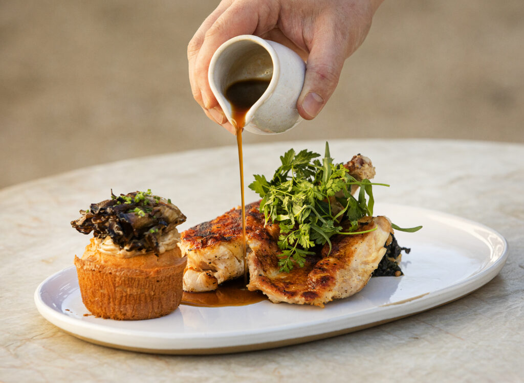 Spatchcock Roast Chicken with porcini corn bread, maitake mushrooms with a pour of Jus at your table from Wit & Wisdom Sonoma. (John Burgess/The Press Democrat)