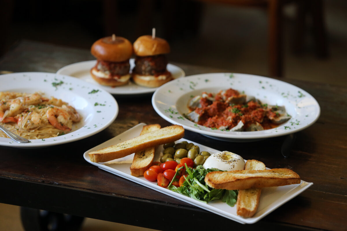 (Clockwise from bottom) Burrata Di Stefano appetizer platter, red chili prawn pasta, meatball sliders, and Nonna's homemade ravioli at Negri's in Occidental. (Beth Schlanker/Sonoma Magazine)