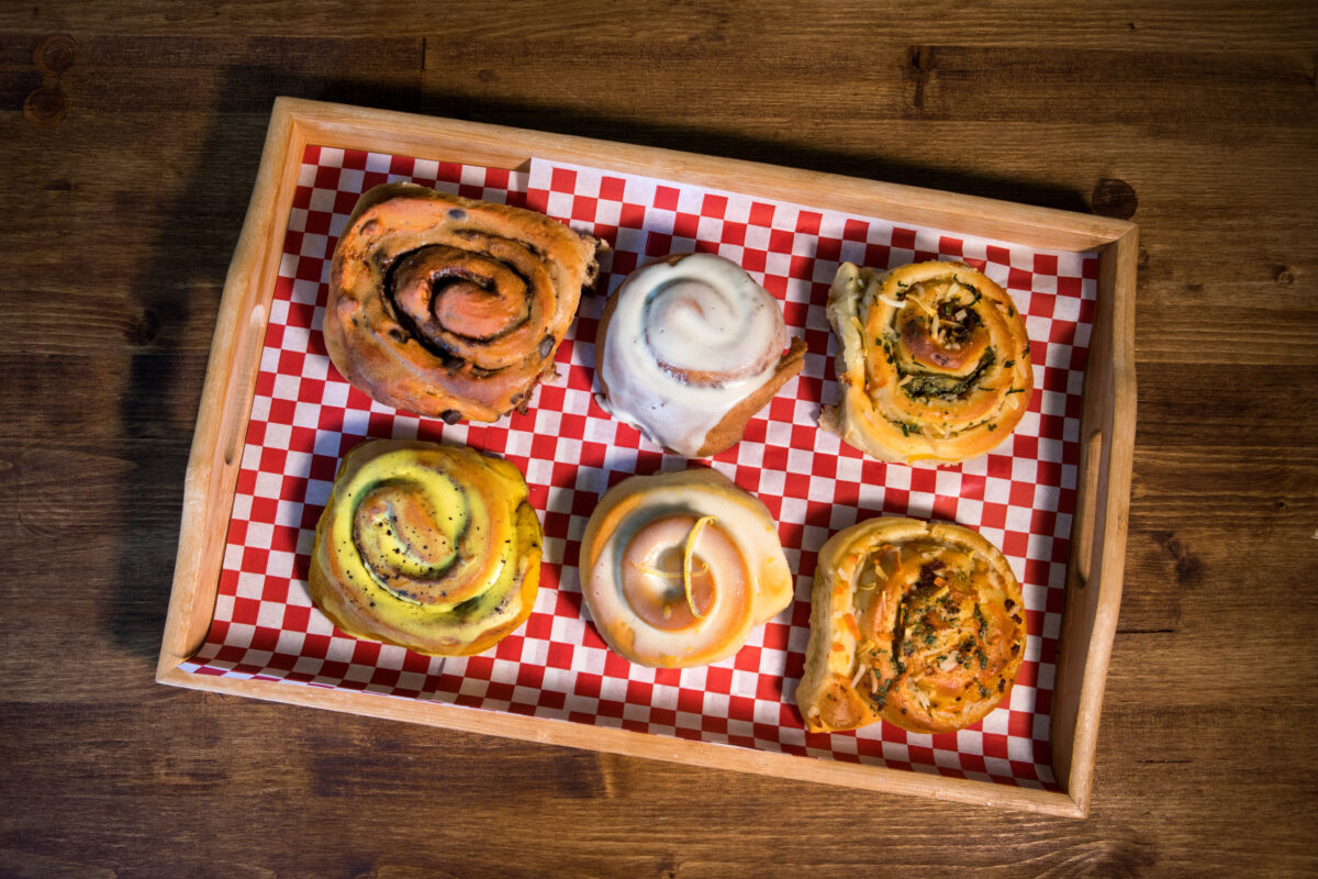 Assorted vegan rolls are top row, left to right: 1) a Chocolate roll with Espresso frosting, 2) a Classic Cinnamon roll with vegan cream cheese frosting, 3) a Soyrizo, Pickled jalapeo, cheese & cilantro roll, and bottom row left to right: 4) a Golden Mlyk Cinnamon roll with vegan chai cream cheese frosting, 5) a Lemon roll with lemon frosting, 6) a Vegor vegan with "Just Egg", Garlic, Cheese & Sweet Earth vegan bacon roll, at Magdelena's Savories & Sweets, in Petaluma, Calif., on Saturday, February 19, 2022. (Photo by Darryl Bush / For The Press Democrat)