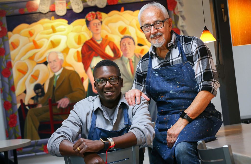 Artist Mario Uribe, right, and Mamadou Diouf opened the Cafe Frida Gallery in the South of A Street arts district, in Santa Rosa. (Christopher Chung/The Press Democrat)