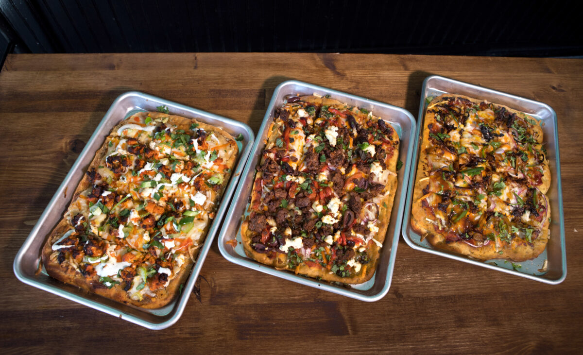 Vegan sheet pan pizzas, from left are: "Buffalo Cauliflower Blue" with "Black Sheep Greek" and "Korean BBQ Pulled Shrooms" at Magdelena's Savories & Sweets in Petaluma. (Darryl Bush/For The Press Democrat)
