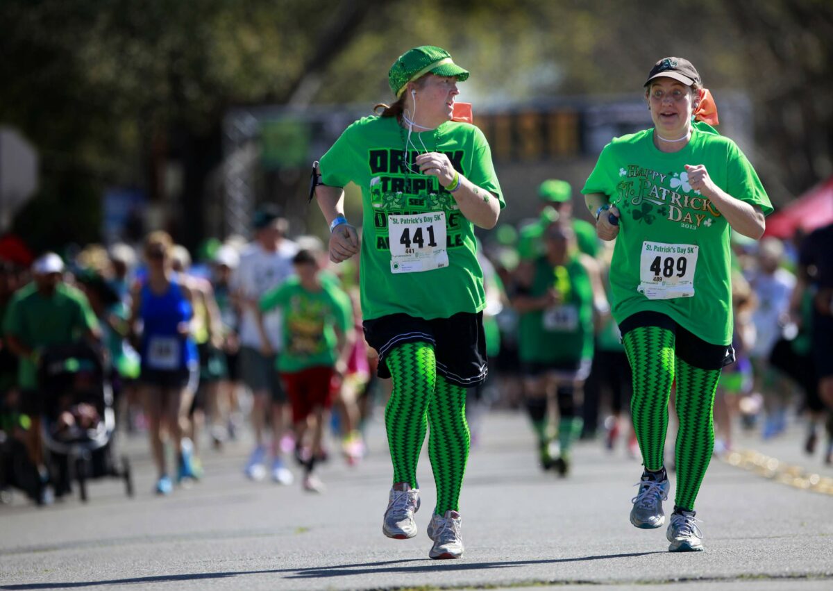 Runners Barbara Nguyen, left, and Cindy Phillips run along A St. during the St. Patrick's Day 5K in Santa Rosa, on Sunday, March 16, 2014. (Beth Schlanker/The Press Democrat)
