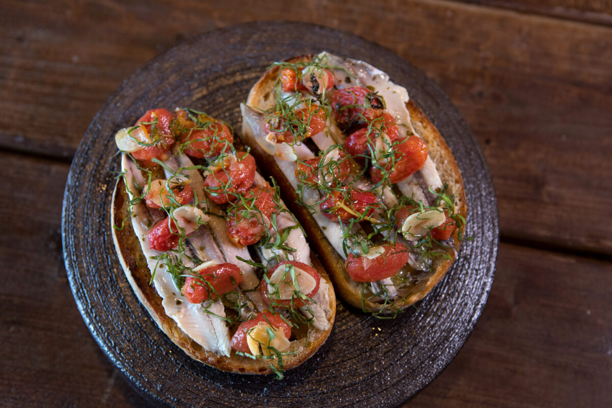 Boquerones Toast includes white anchovies, roasted cherry tomatoes and basil at Animo restaurant in Sonoma. (Darryl Bush/For The Press Democrat)