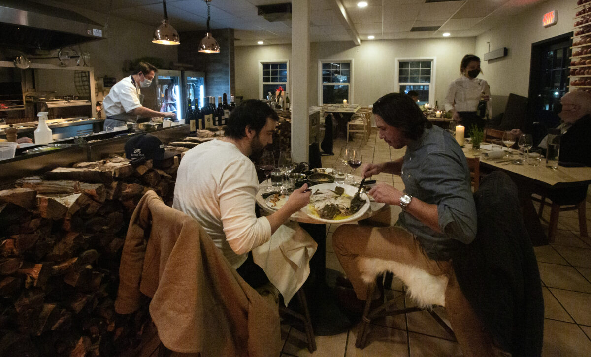 an Lennon, left, and Ben Flajnik enjoy a meal on the opening day of the restaurant Animo on Highway 12, near the intersection of Verano Avenue on Wednesday, Feb. 2, 2022. (Robbi Pengelly/Sonoma Index-Tribune)