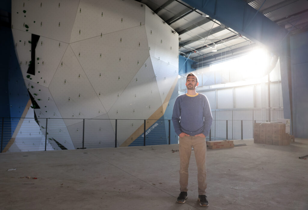 Kevin Jorgeson, co-founder of Session Climbing, stands on the mezzanine level still under construction. (Christopher Chung/The Press Democrat)