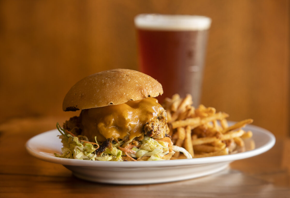 Carolina Gold BBQ Pulled Pork on a brioche bun with cheddar cheese, cabbage slaw and fries from Reel & Brand in Sonoma. (John Burgess/The Press Democrat)