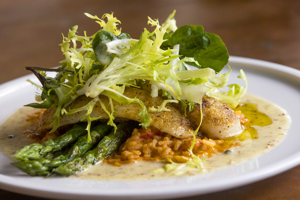 Cajun Spiced Catch of the Day with red rice jambalaya, crayfish, asparagus and dill butter from Easy Rider in Petaluma on Tuesday, March 1, 2022. (John Burgess/The Press Democrat)