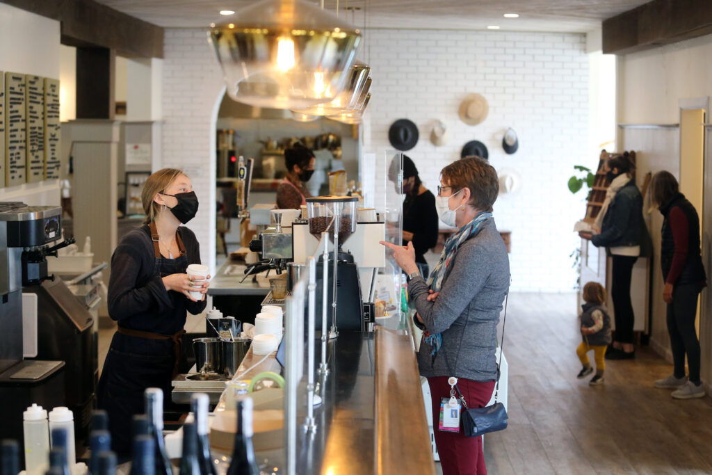 Barista Alana Fraley interacts with a customer as she makes coffee at The Altamont General Store in Occidental, Calif., on Thursday, May 13, 2021. (Beth Schlanker/Sonoma Magazine)