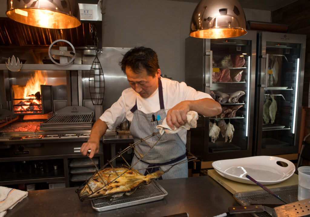 Co-owner, Joshua Smookler, prepares a large turbot fish for serving at his restaurant, Animo, in Sonoma, Calif., on Wednesday, March 30, 2022. (Photo by Darryl Bush / For The Press Democrat)