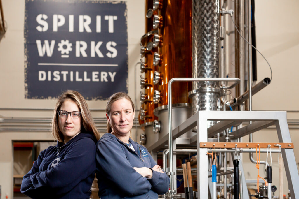 Spirit Works Distillery Head Distiller Krystal Goulart and co-ower Ashby Marshall stand in front of their still in the production facility at The Barlow in Sebastopol. Spirit Works is one of seven local businesses that have been honored with a 2022 Good Food Award. (Loren Hansen Photography)