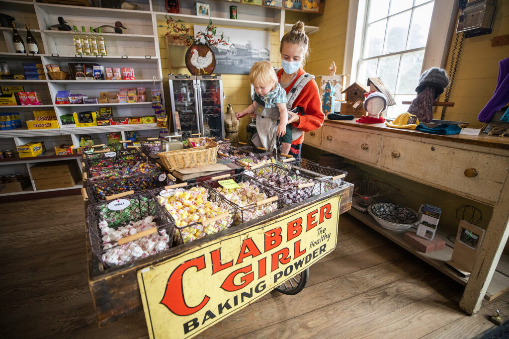 Laura Holford and son Isaac Charlebois, 1, looks through a selection of old fashioned treats at the Stewart's Point Store and the Twofish Baking Co. on Highway 1. (John Burgess/The Press Democrat)