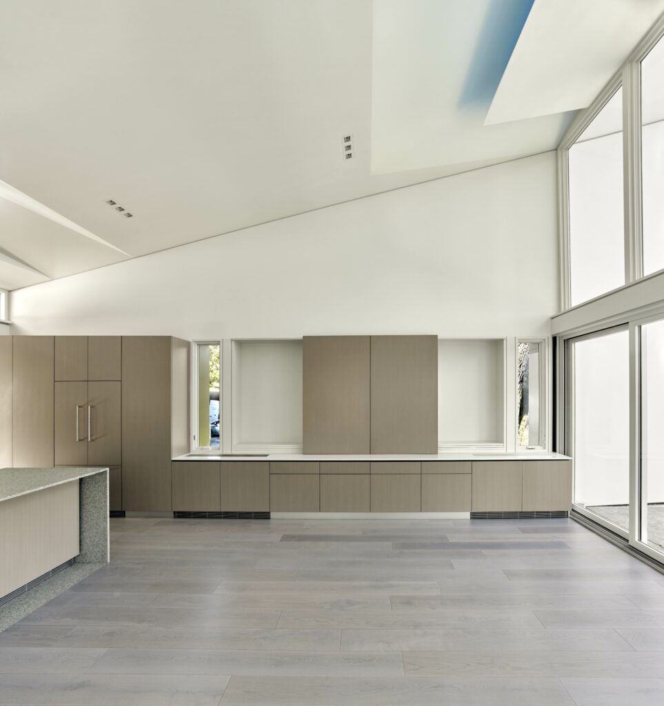 Kitchen and living area with cabinets that hide a TV screen. (Cesar Rubio)