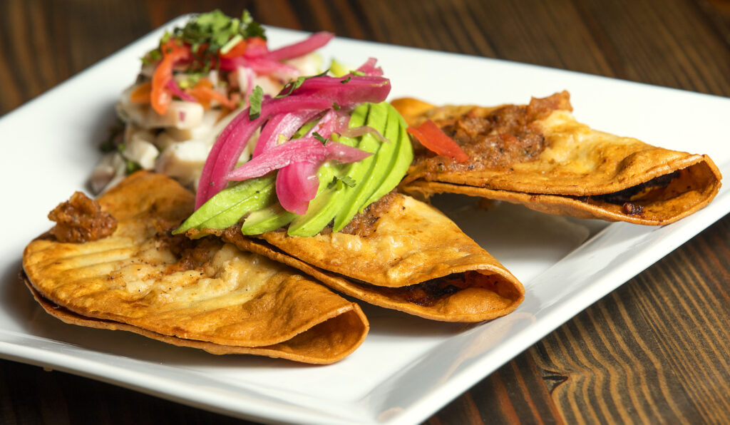 Tacos Dorados de Picadillo with beef and ceviche from Pezcow in Windsor on Friday, April 1, 2022. (John Burgess/The Press Democrat)