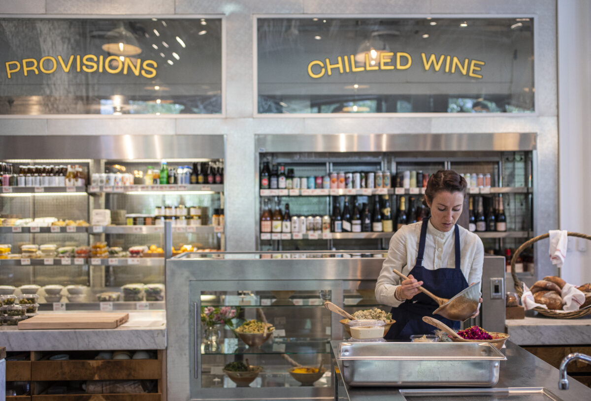 Leslie Schulz of Little Saint prepares a to-go order in downtown Healdsburg on April 22, 2022. (Chad Surmick/The Press Democrat)