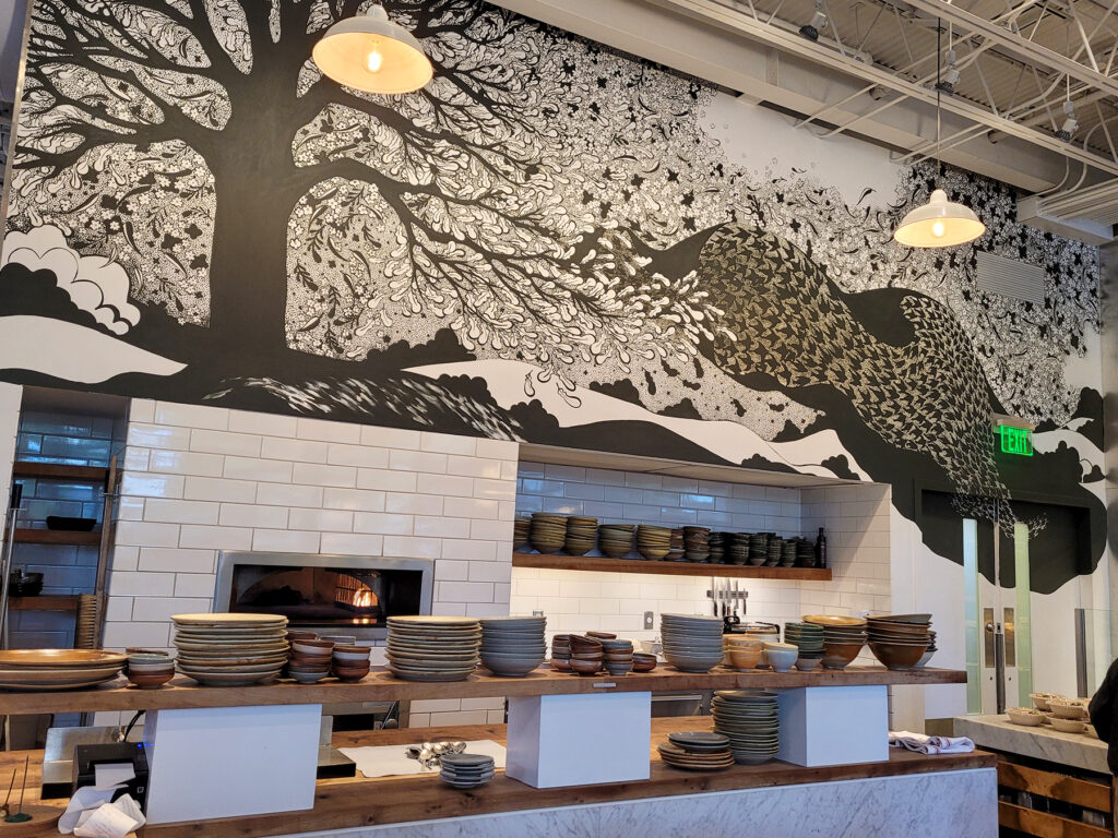 A mural graces the cafe kitchen wall at Little Saint in Healdsburg. (Heather Irwin/The Press Democrat)