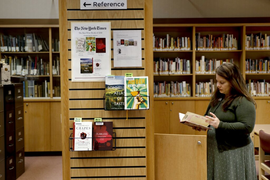 Megan Jones, curator of the Sonoma County Wine Library, checks a for a copy of book at the library in Healdsburg on Tuesday, March 19, 2019. (Beth Schlanker/The Press Democrat)