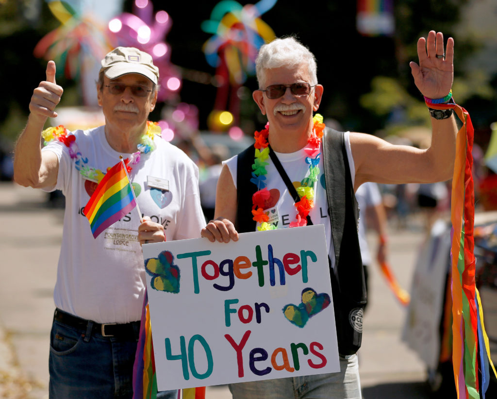 John Kennedy, left, and Bill Baird, who have been together for 40 years, walk down 4th Street with a group from Fountaingrove Lodge during the Sonoma County Pride Parade in Santa Rosa, California, on Saturday, June 1, 2019. (Alvin Jornada / The Press Democrat)