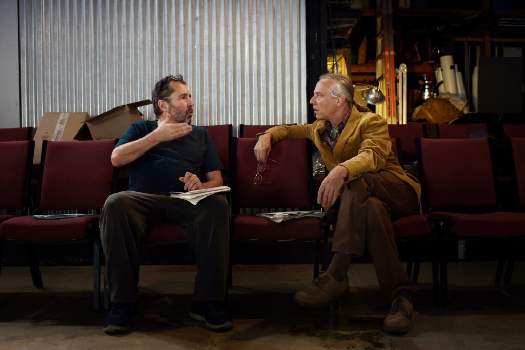 Hungarian director Árpád Schilling, left, and Imaginists theater co-founder and actor Brent Lindsay during a dress rehearsal for “S D A (Someone Dies Again),” a new work that focuses on the role that gun violence play in American society at The Imaginists theater in Santa Rosa, Calif., on Monday, April 30, 2022. (Erik Castro/For The Press Democrat)