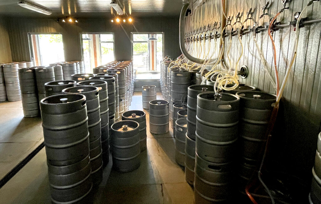 Windows allow patrons to view the refrigerated keg room at the new Crooked Goat Brewing Co. taproom on Howard St. in Petaluma on May 17, 2022. (John Burgess/The Press Democrat)