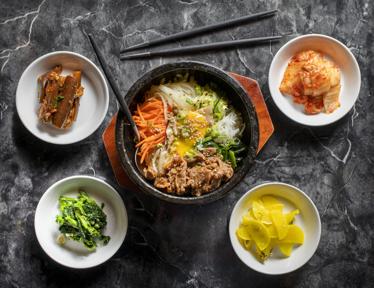 Dolsot Bibimbap, rice topped with vegetables and fried egg in a sizzling stone pot with beef, with traditional Korean side dishes from Soban Korean in Petaluma. (John Burgess/The Press Democrat)